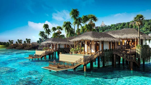 resort in vietnam Scenic view of tropical overwater villas surrounded by clear blue water and palm trees in Vietnam.