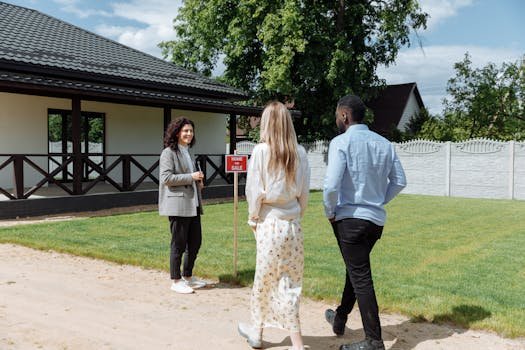 pexels-photo-8469946-8469946 A diverse group viewing a house for sale with a real estate agent outdoors.