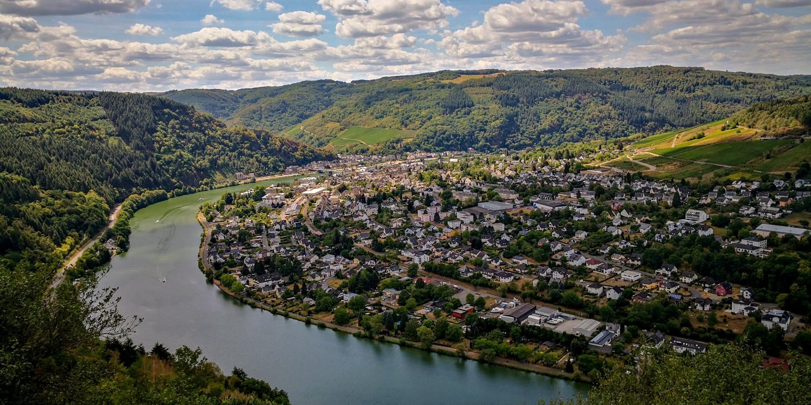 Explore Traben-Trarbach's charming landscape with hills and river views in this aerial photograph.